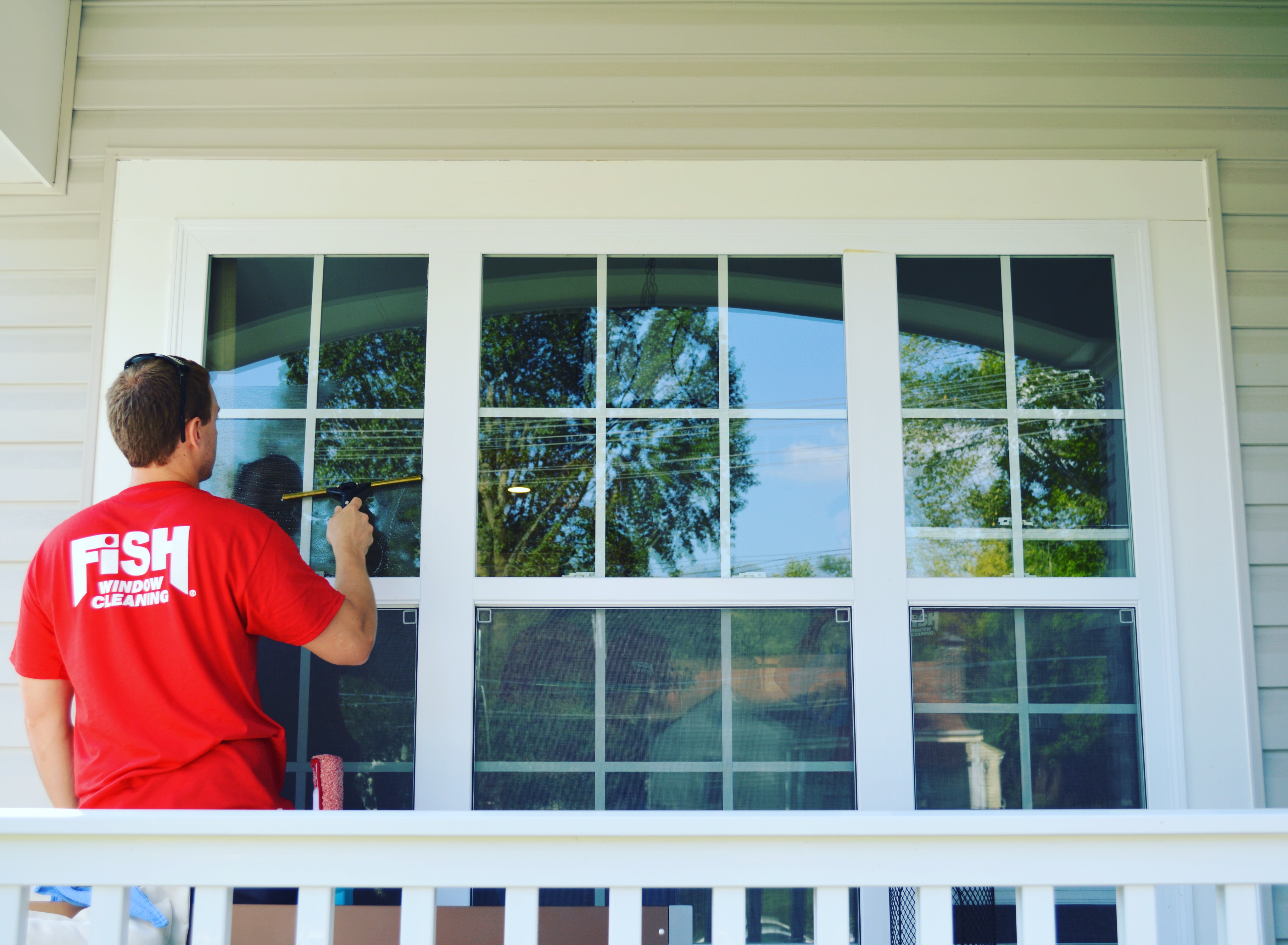 Fish Window Cleaner Cleaning Outside of Home's Windows